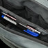 A close-up of the Tech Pouch by Condor in gray shows two pens—one with blue ink and one with silver trim—neatly organized in dedicated pen slots.